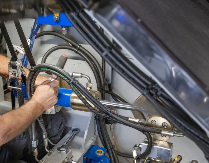 Man laying down fuel systems inside a yacht